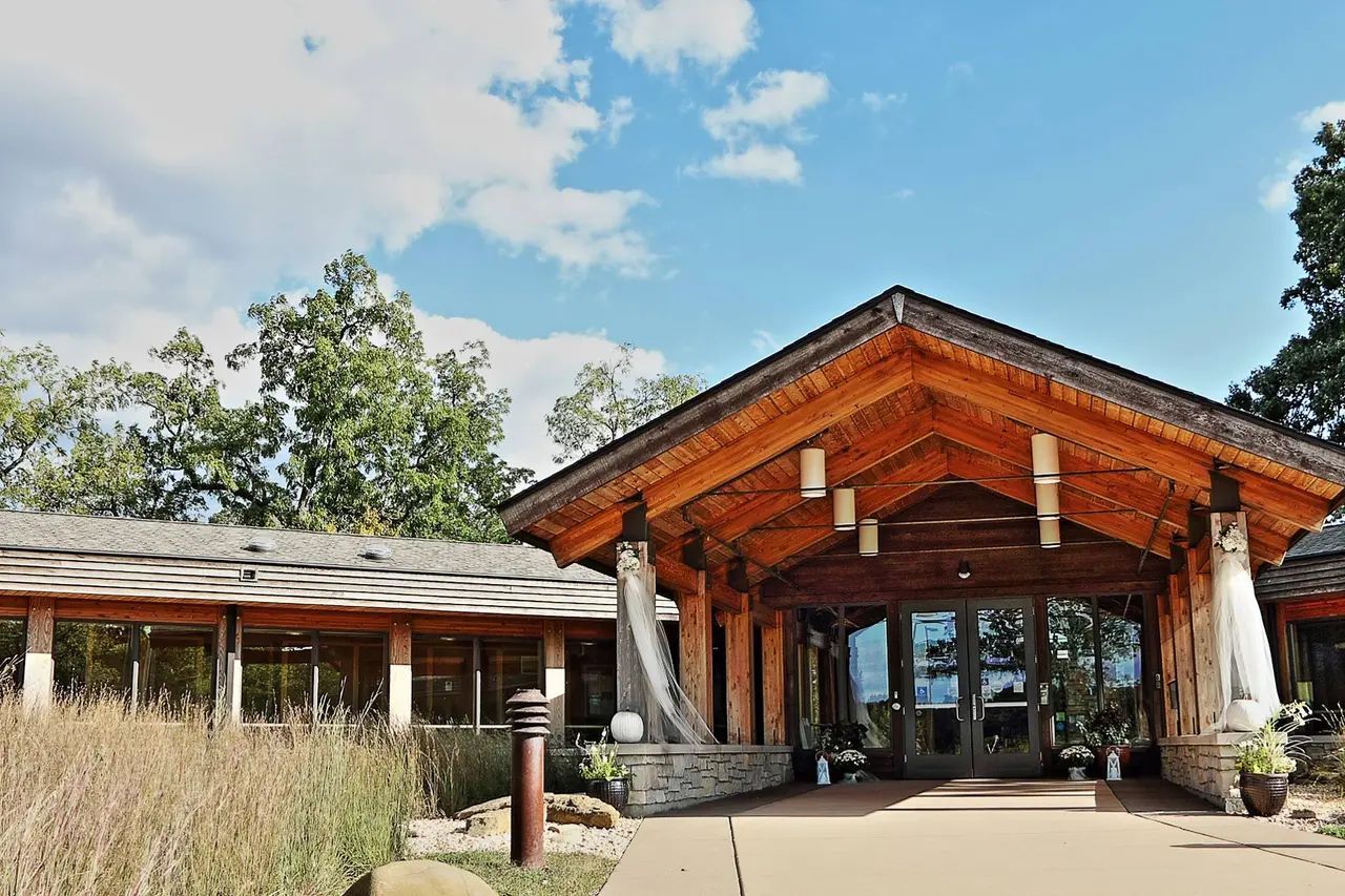 A large wooden building with a roof that is covered in shingles.