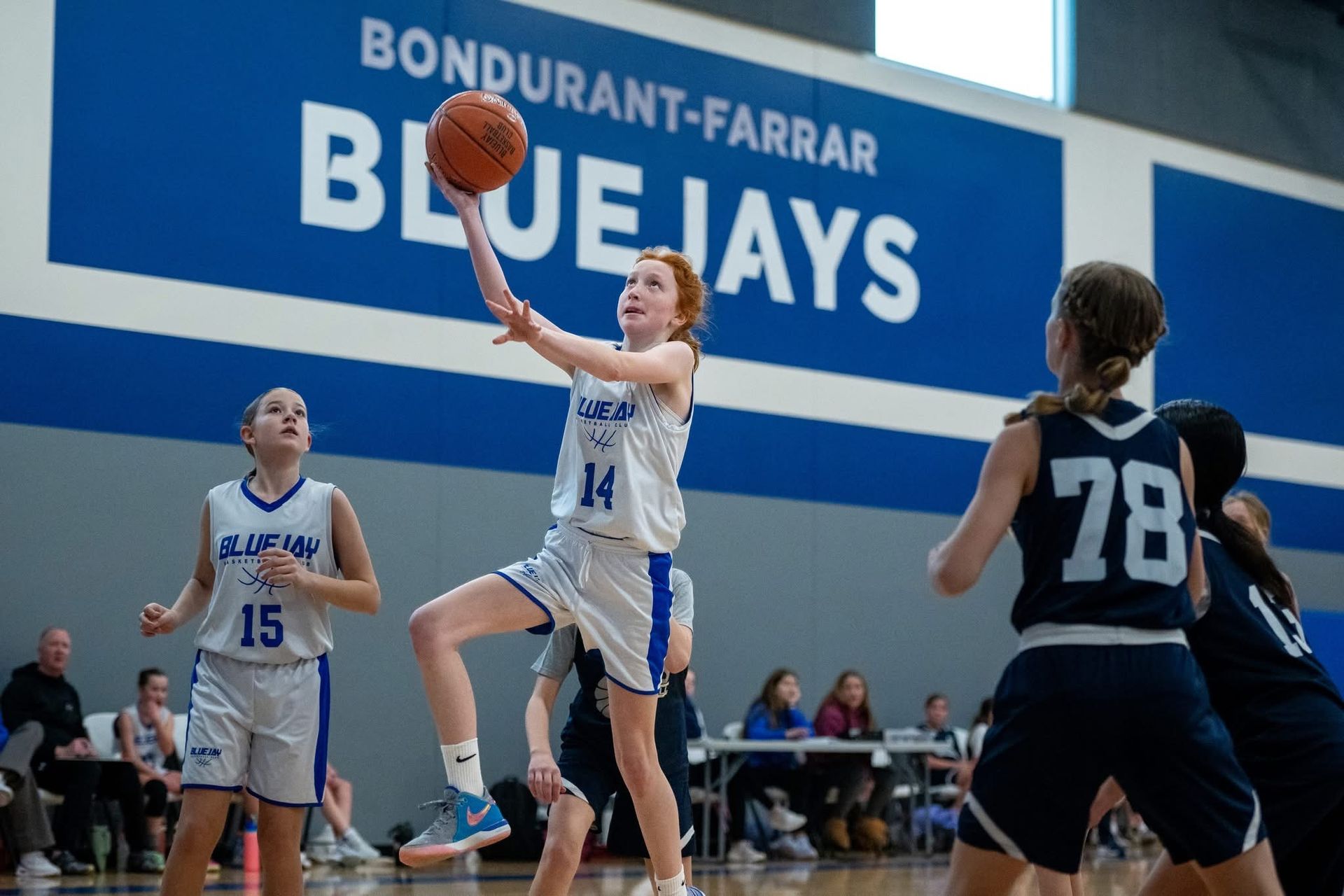 Bluejay Basketball Club player attacks hoop. 
