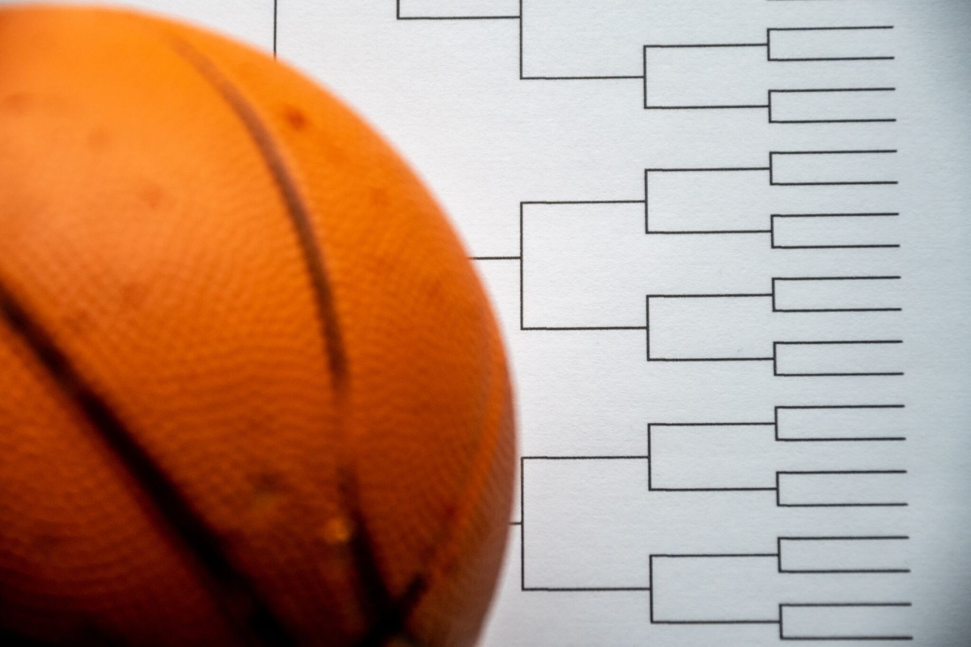 Orange basketball with bracket diagram on a white background