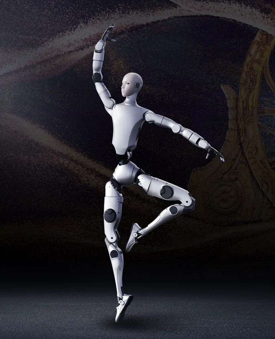 Robot with silver body and blue head lighting standing against a gray backdrop.