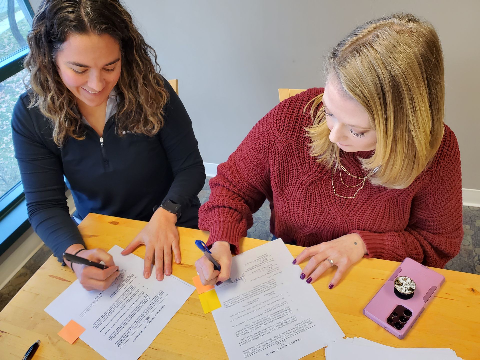 Amelia Barker-King and Jennifer Sawyer review documents together