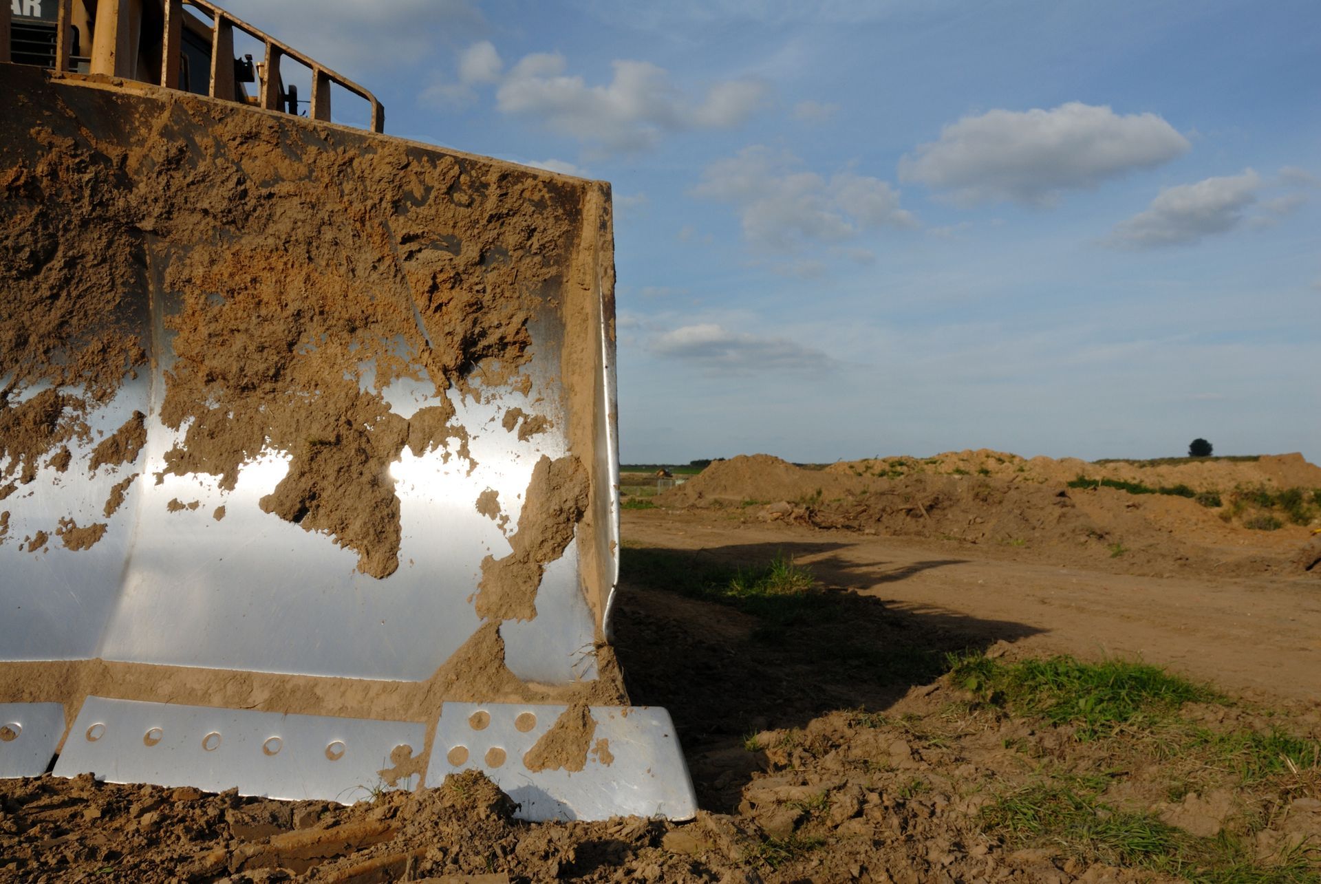 A bulldozer is moving dirt in a field