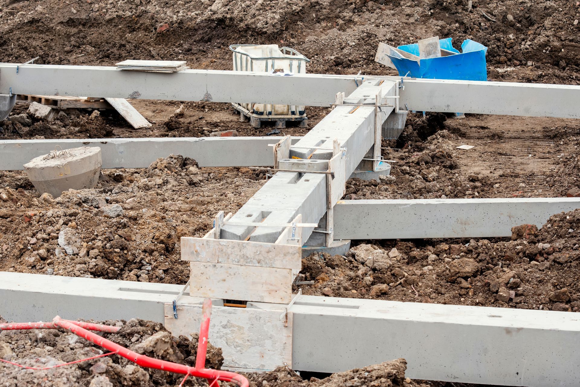 A concrete structure is being built in the dirt on a construction site.