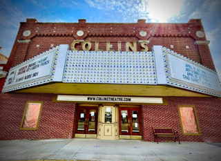 Historic Collins theater facade with marquee and red brick exterior under a blue sky