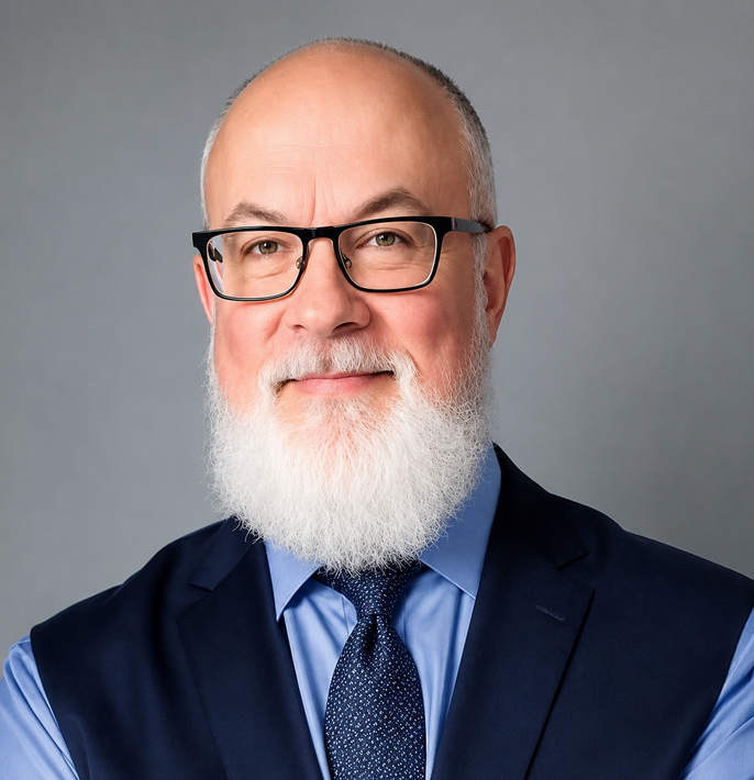 Portrait of a smiling man in glasses, blue shirt, patterned tie, and vest against a gray background