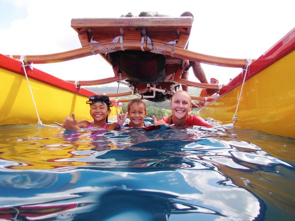 Family swimming in ocean