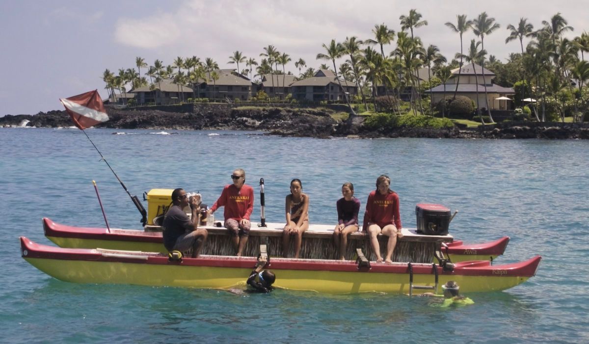 family on Hawaiian double hull canoe