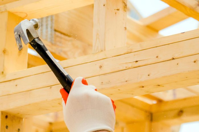 man repairing wooden deck