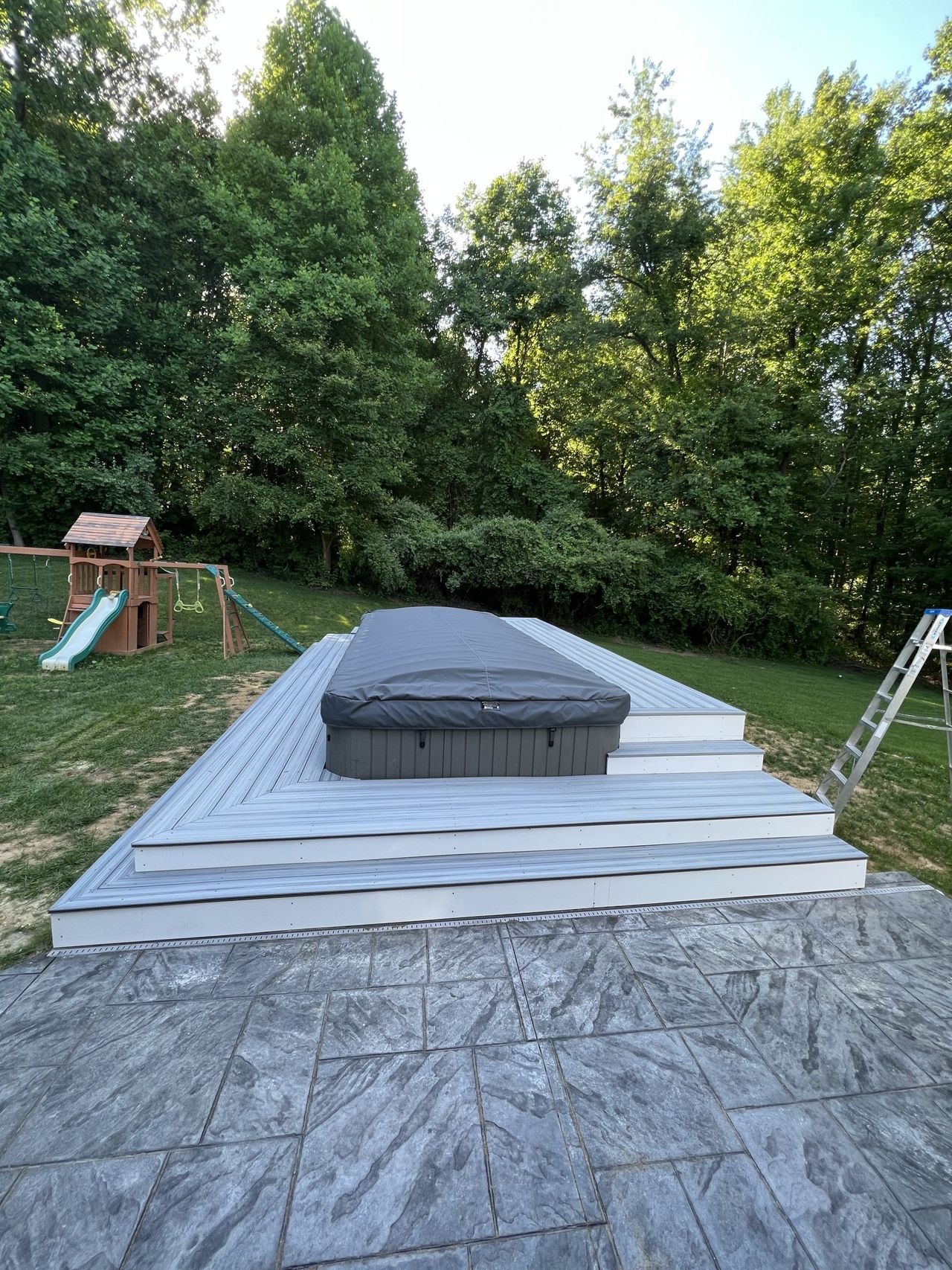 Finished composite platform and patio around a hot tub, a Handyman on Demand project