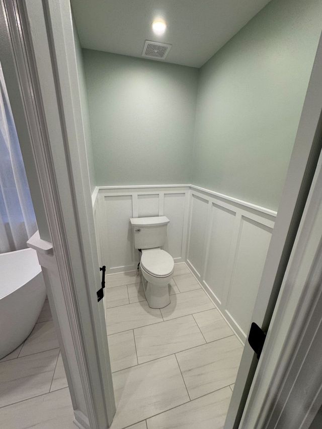 Toilet room with new board-and-batten wainscoting, a Handyman on Demand project