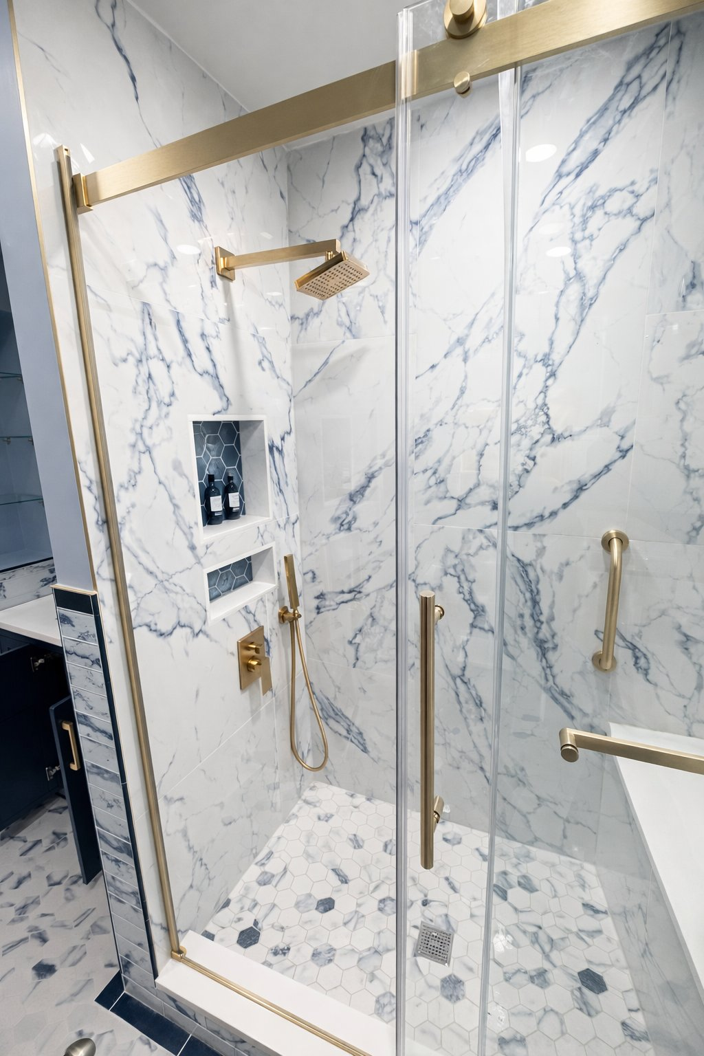 Custom bathroom renovation in Clarksville MD featuring blue marble tile walk-in shower, brushed gold rain head, dual recessed niches, and gold sliding glass door by Handyman on Demand