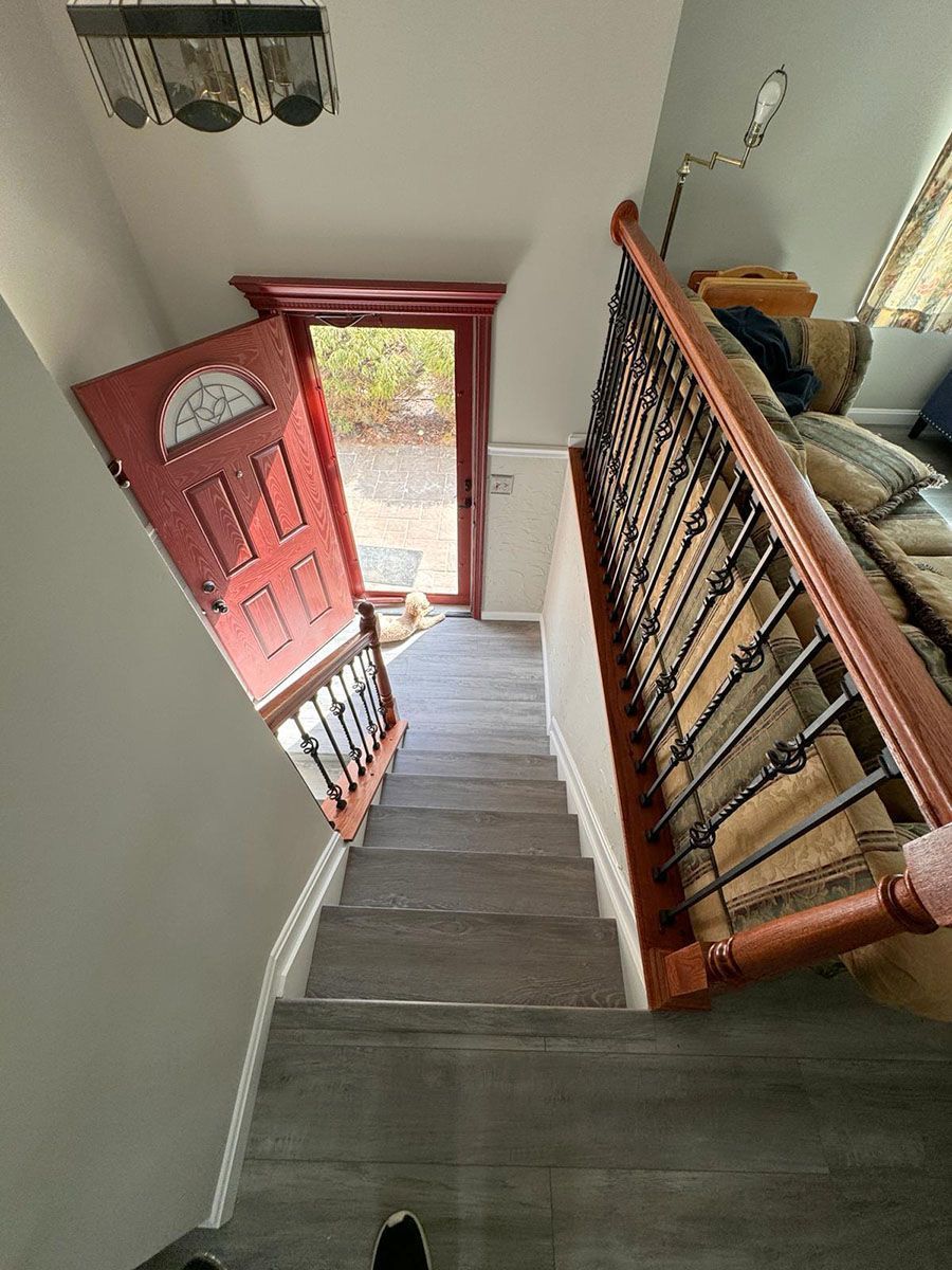 Staircase refinished with new treads and railing by Handyman on Demand