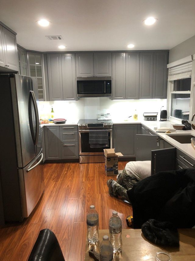 Gray kitchen cabinets and stainless appliances - Handyman on Demand
