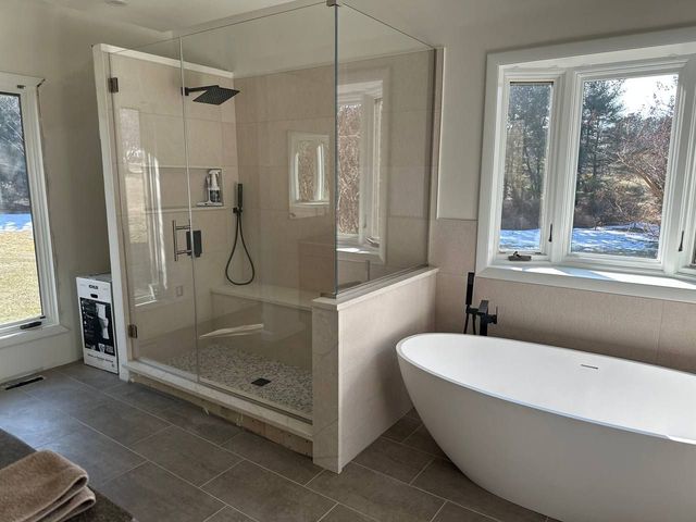 Primary bathroom with a glass walk-in shower and freestanding tub