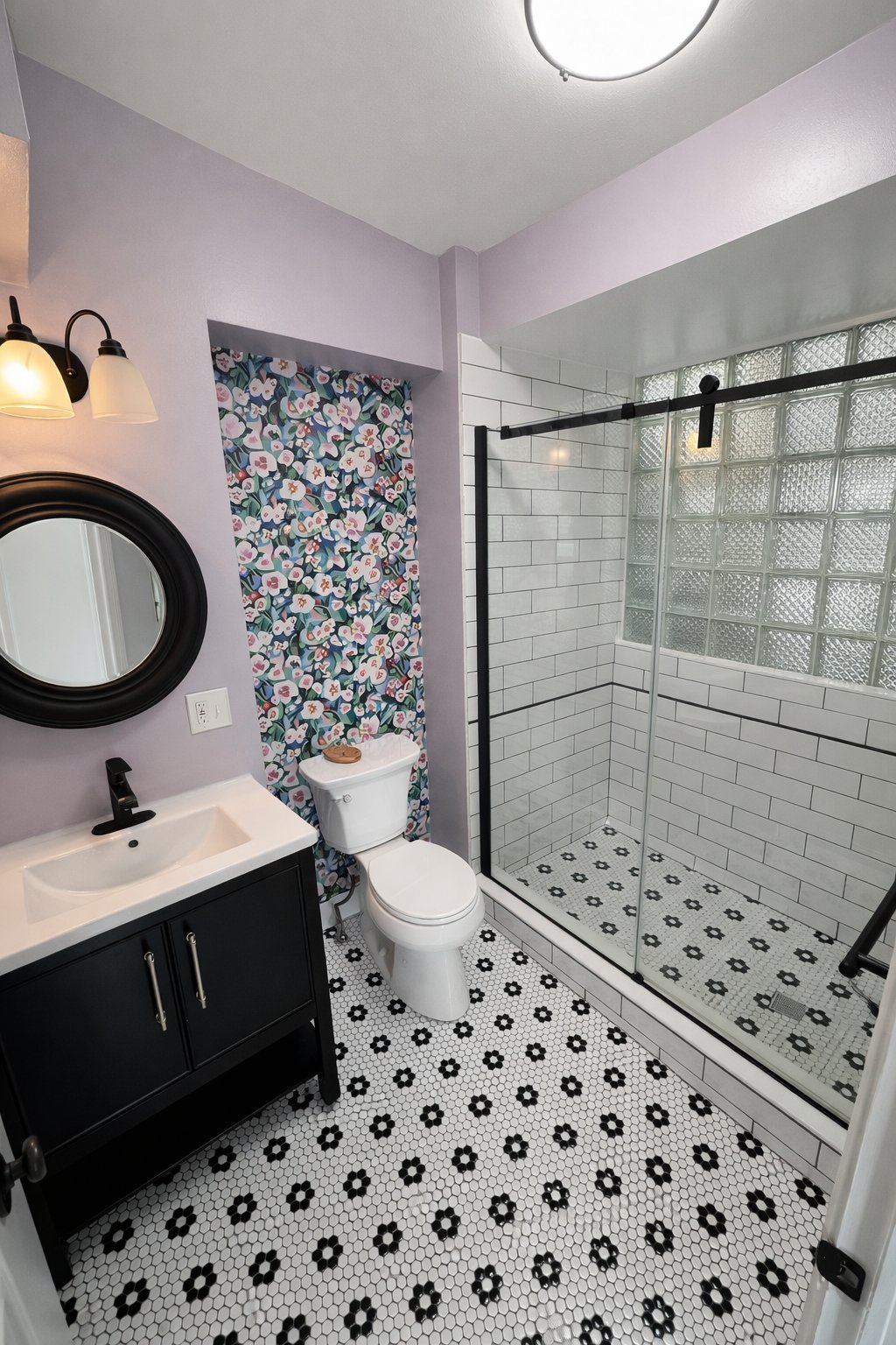 Affordable small bathroom remodel in Clarksville MD with subway tile shower, glass block window, black and white mosaic floor tile, and black vanity by local contractor Handyman on Demand