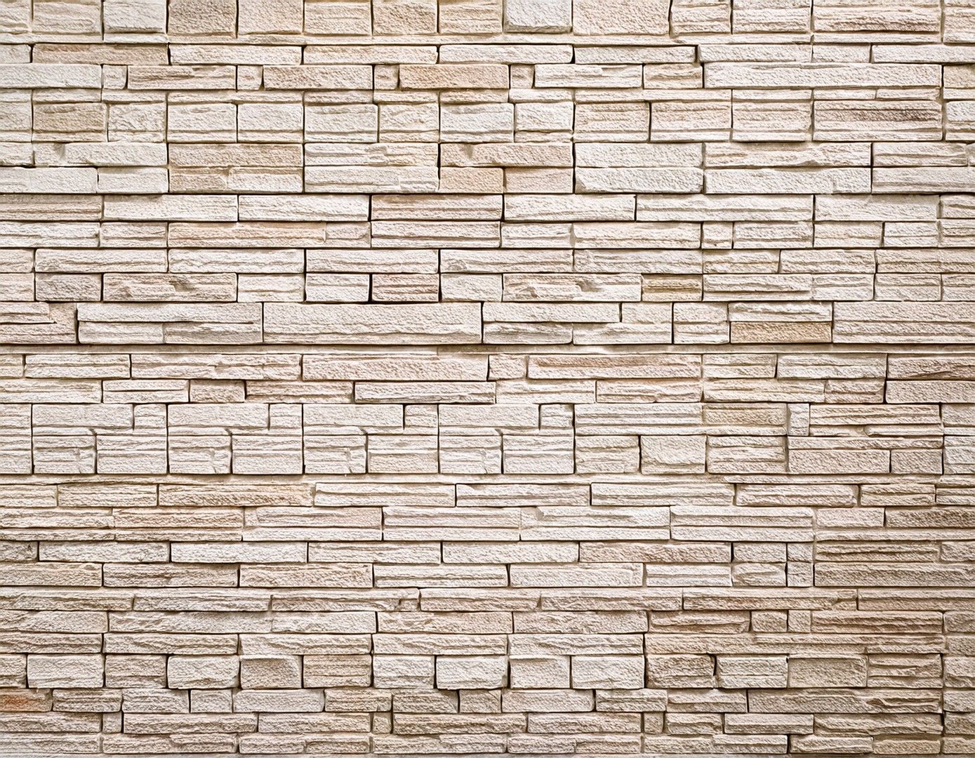 Tan brick wall with textured horizontal and vertical lines.