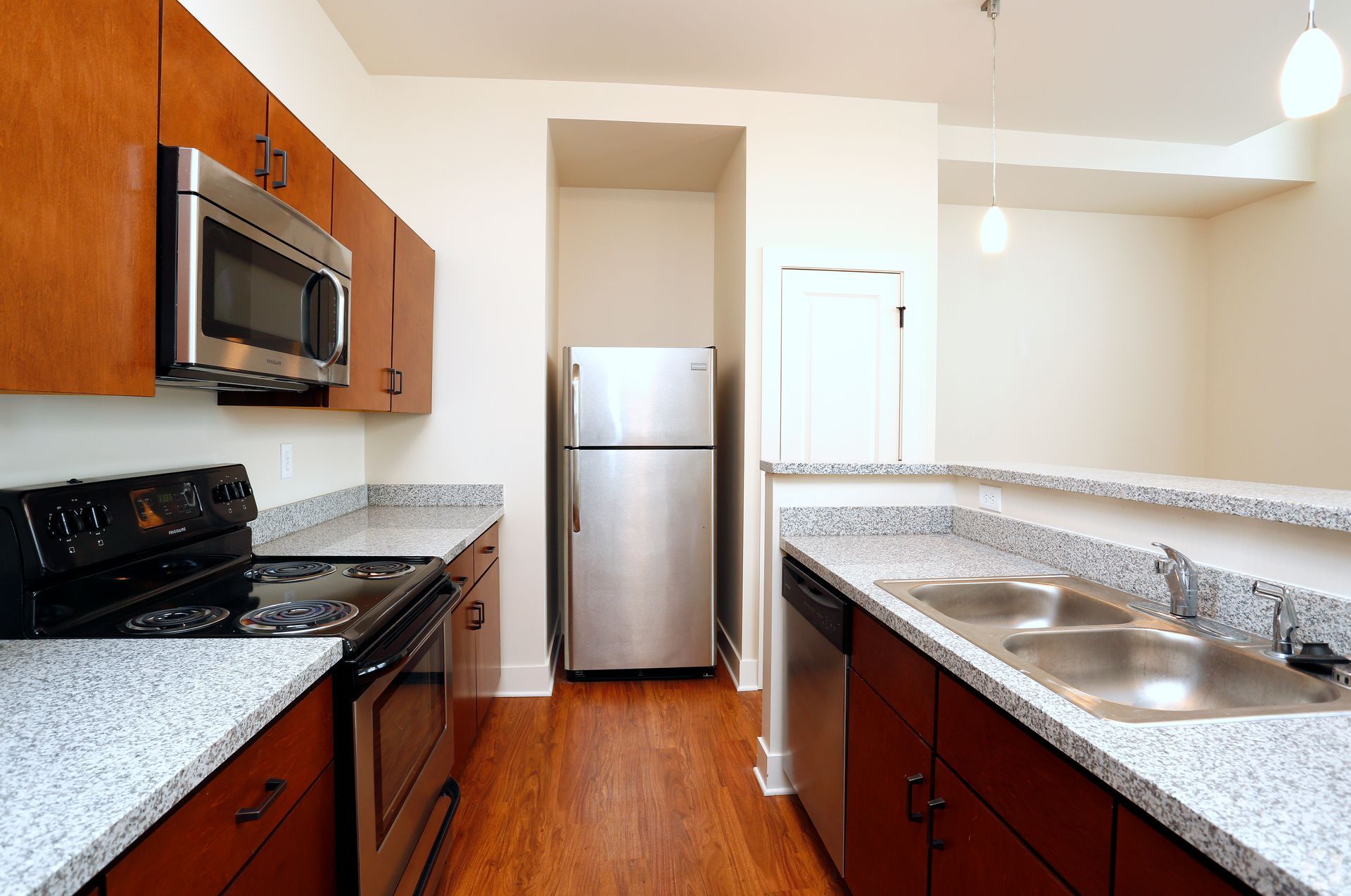 A kitchen with stainless steel appliances and granite counter tops