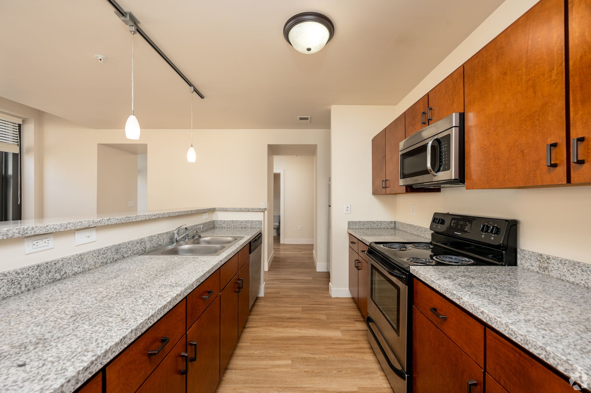 A kitchen with granite counter tops and wooden cabinets