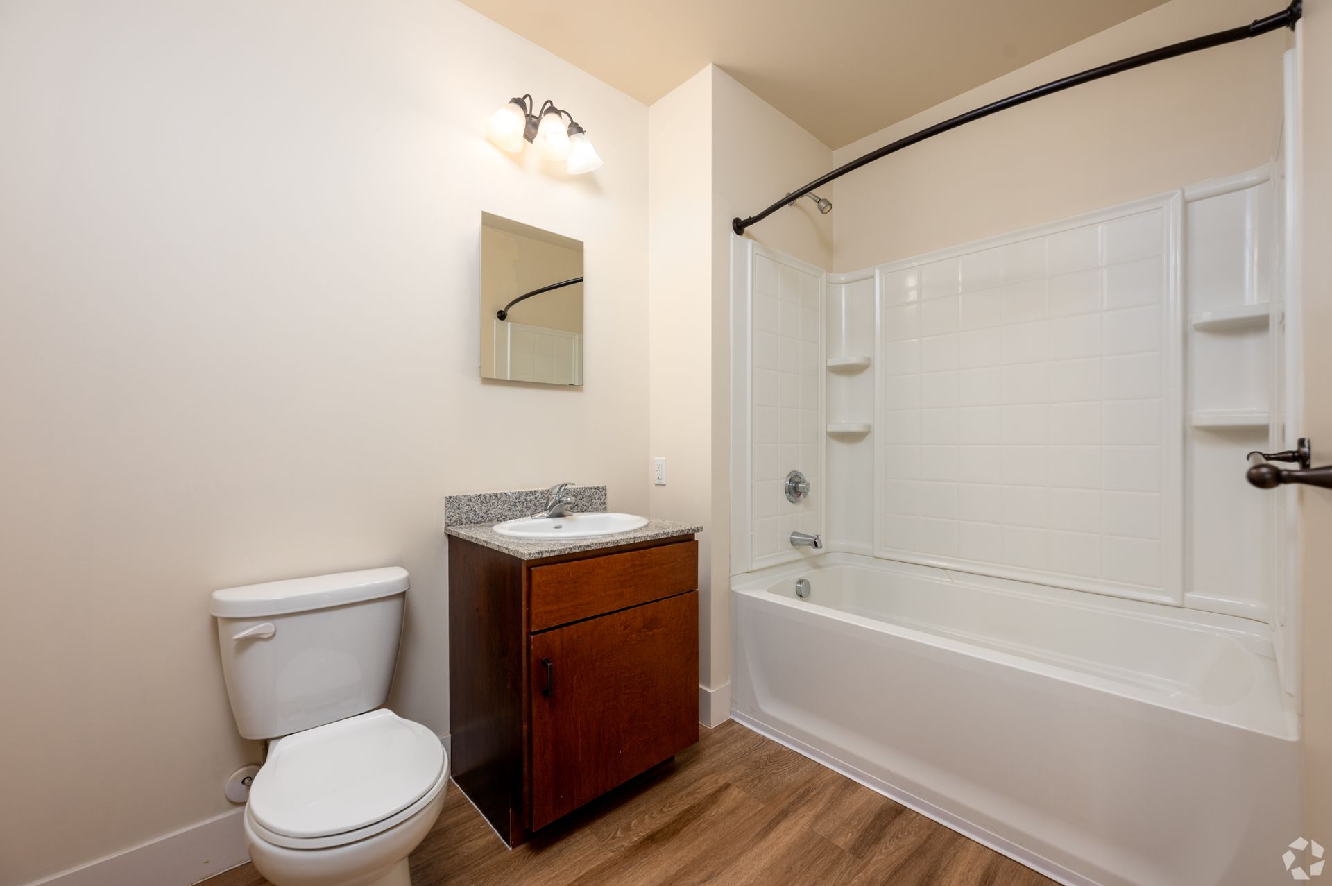 A bathroom with a toilet , sink , and bathtub.
