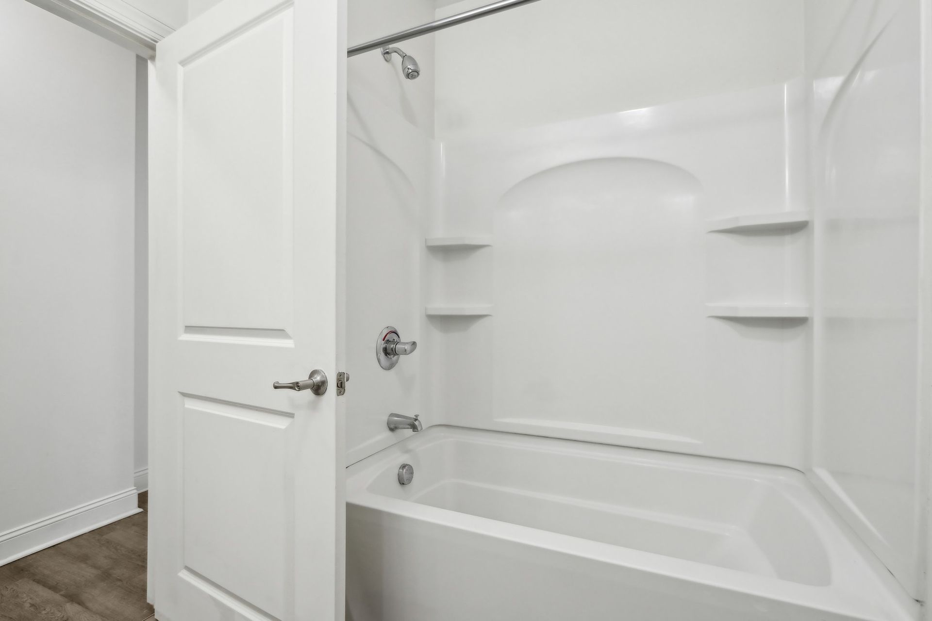 A bathroom with a bathtub and shower stall.