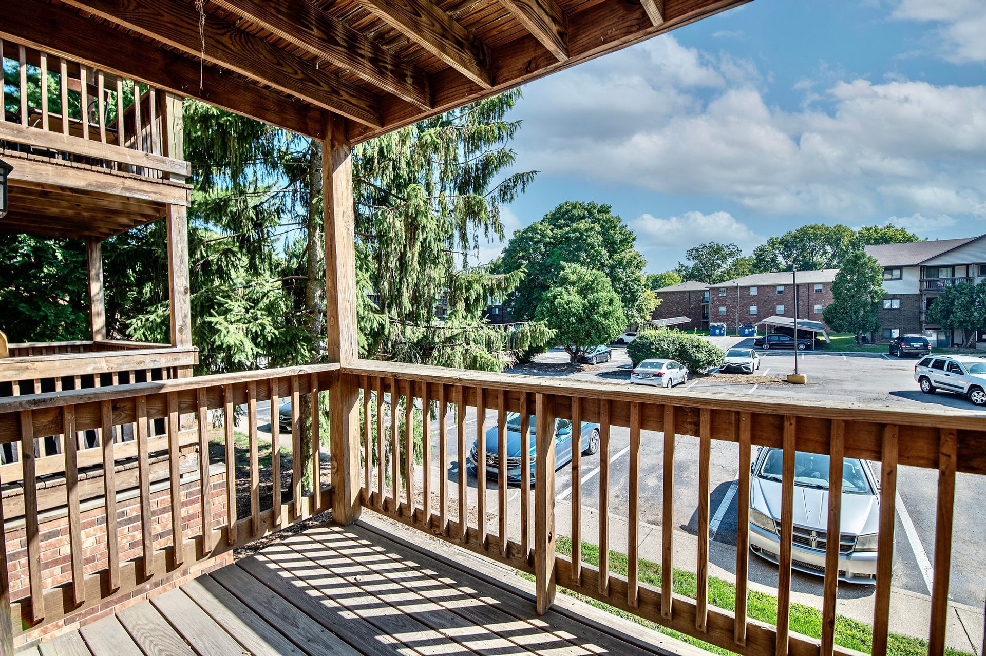A wooden deck with a view of a parking lot
