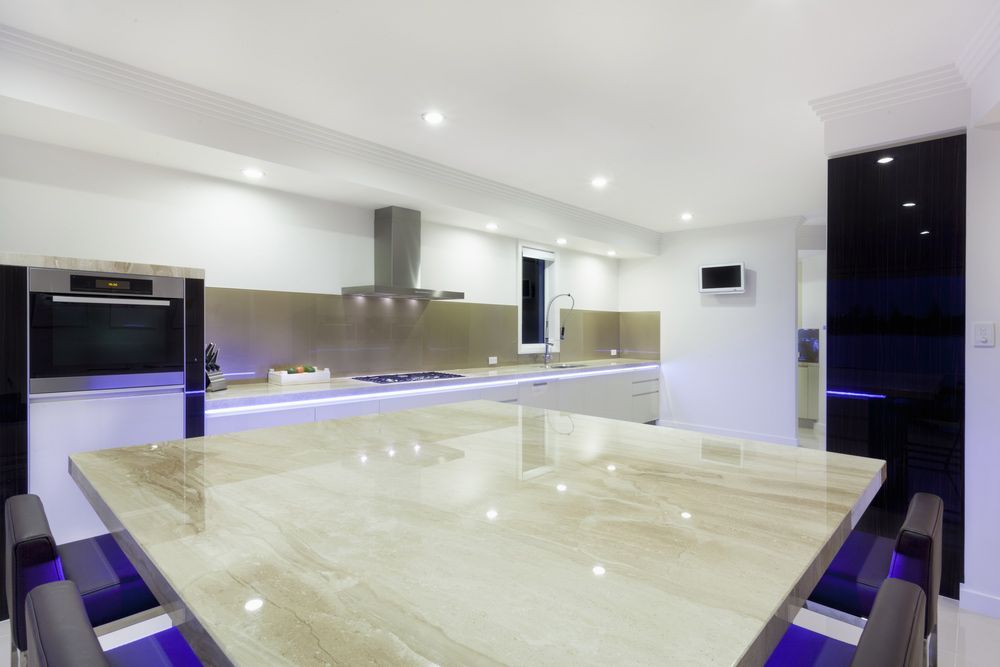 A Kitchen With A Large Marble Table And Chairs — Universal Marble & Granite In Yamba, NSW