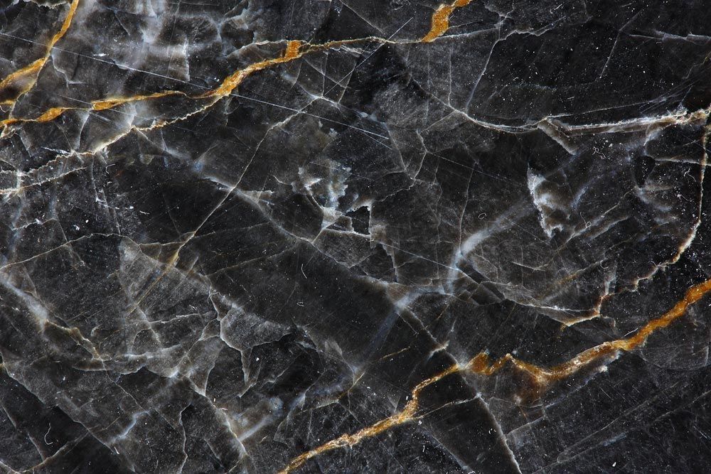A Close Up Of A Black Marble Texture With Gold Veins — Universal Marble & Granite In Scotts Head, NSW