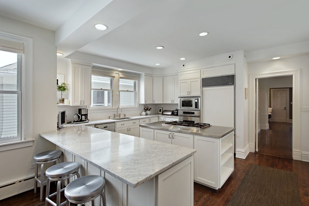 A Kitchen With Cabinets And Granite Counter Tops — Universal Marble & Granite In Cleveland, QLD