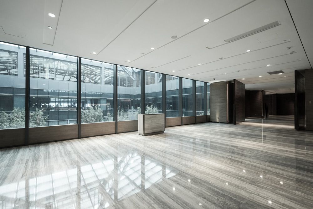 A Large Empty Room With A Lot Of Windows And A Marble Floor — Universal Marble & Granite In Woolgoolga, NSW