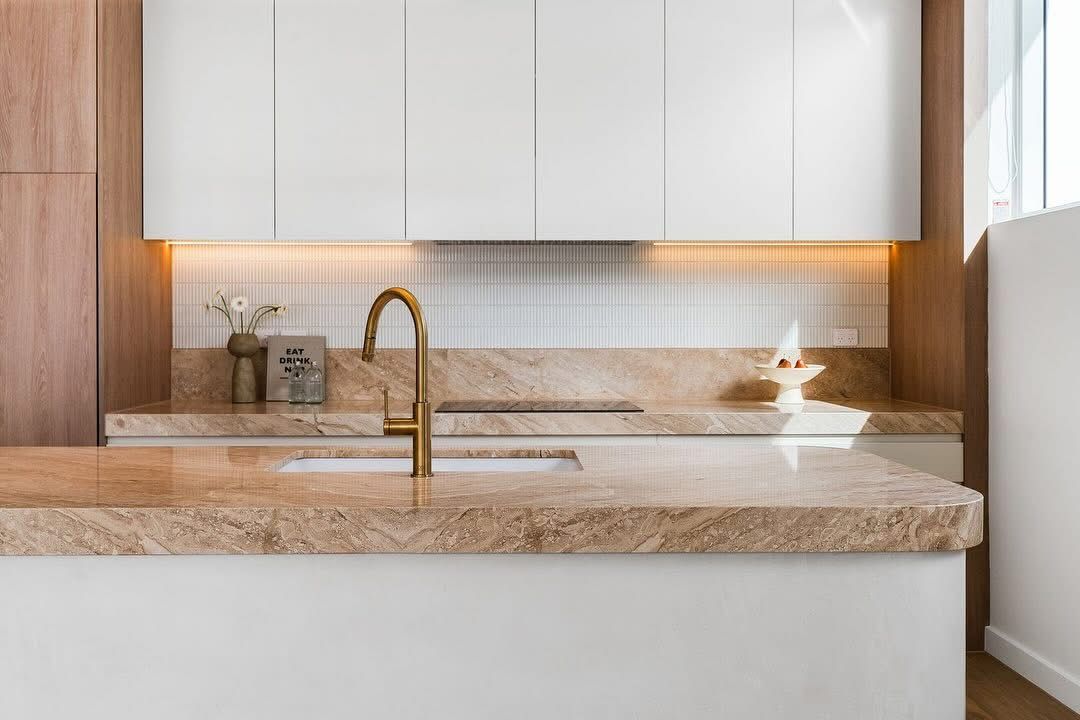 A Large Marble Kitchen Top with bright lighting under cabinets — Universal Marble & Granite In Woolgoolga, NSW