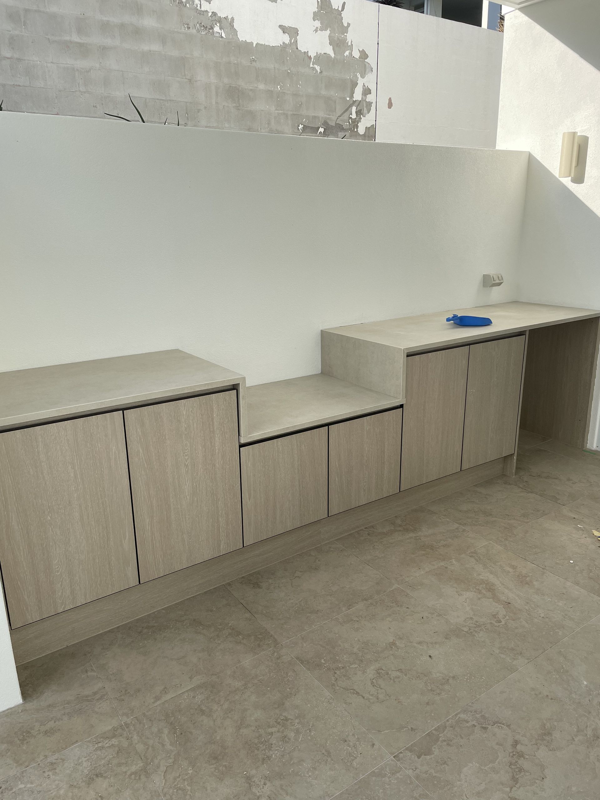 An outdoor kitchen space with light oak cabinets  — Universal Marble & Granite In Gold Coast, QLD