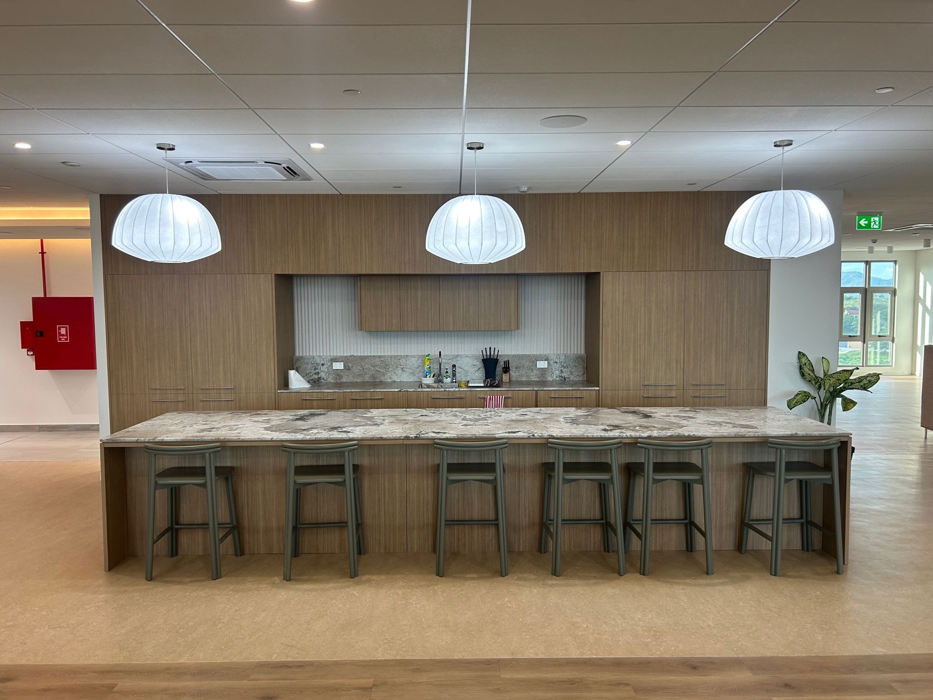A large kitchen area with dark oak cabinets and marble countertop  — Universal Marble & Granite In Woolgoolga, NSW