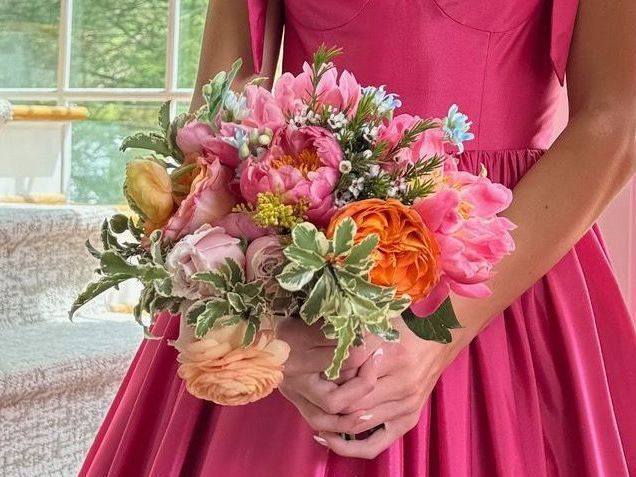 A tiara is sitting on top of a bouquet of flowers.