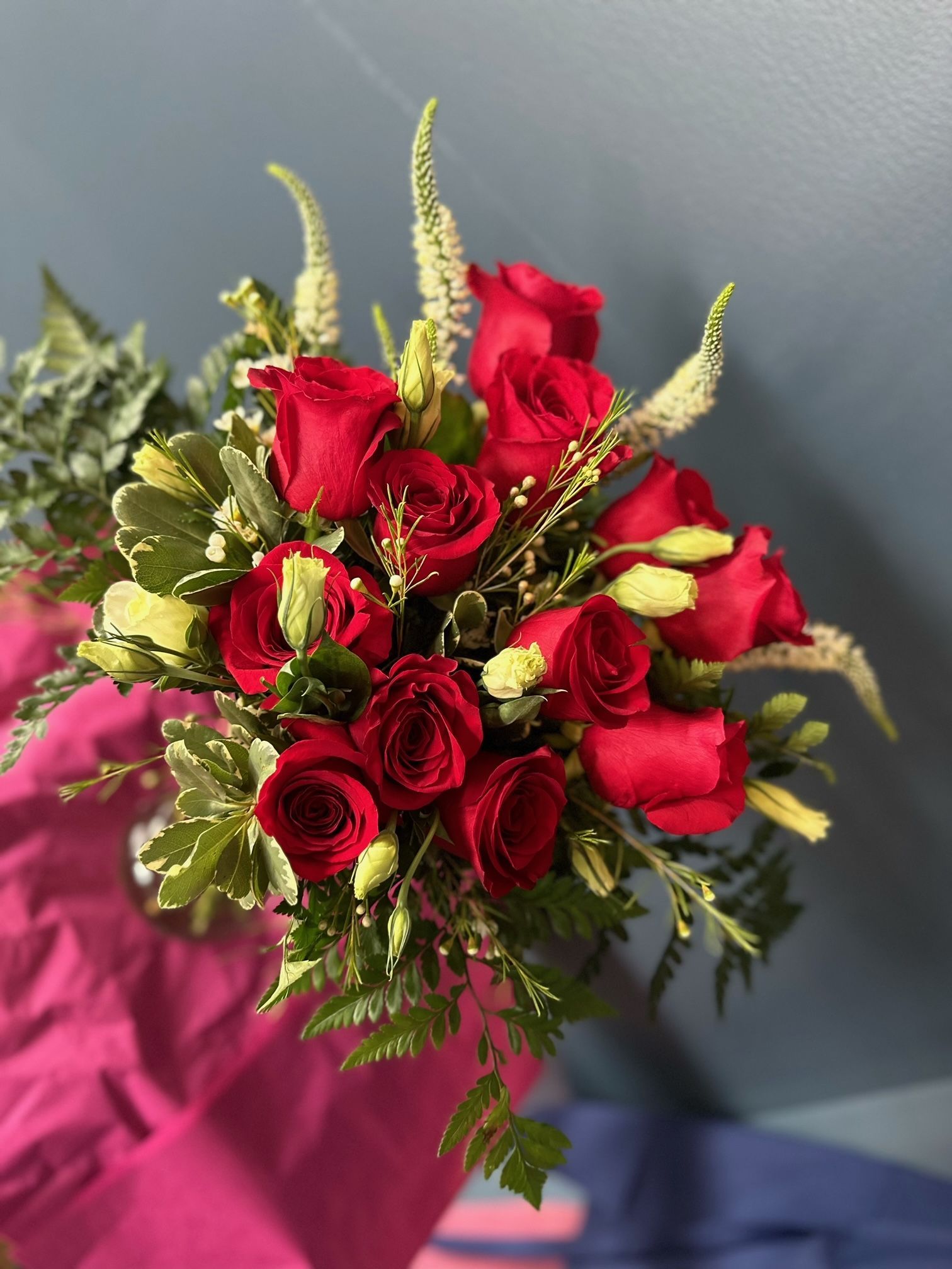 A close up of a bouquet of white roses and baby's breath.