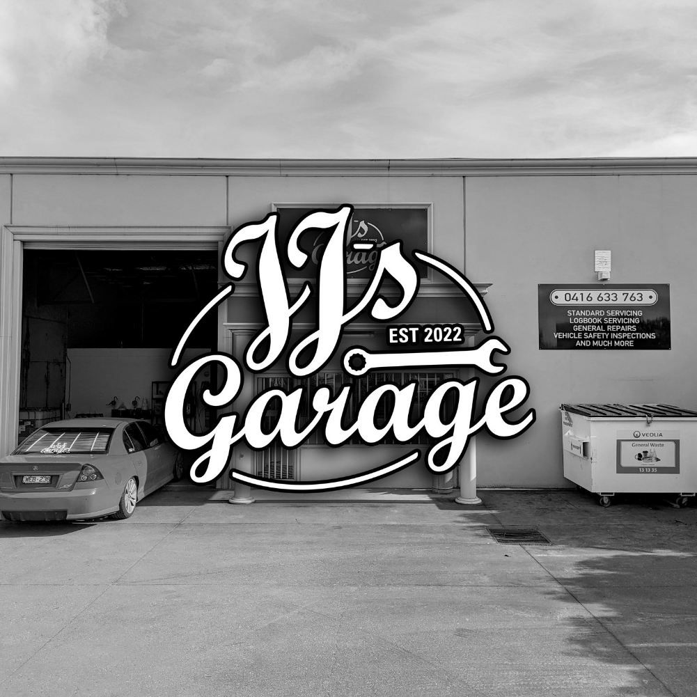 A Black and White Photo of a Garage With a Car Parked in Front of It — JJ's Garage In South Geelong, VIC
