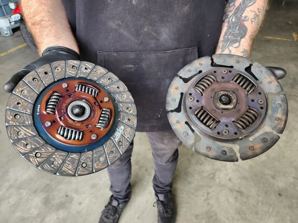 A Man is Holding Two Clutch Discs in His Hands — JJ's Garage In South Geelong, VIC