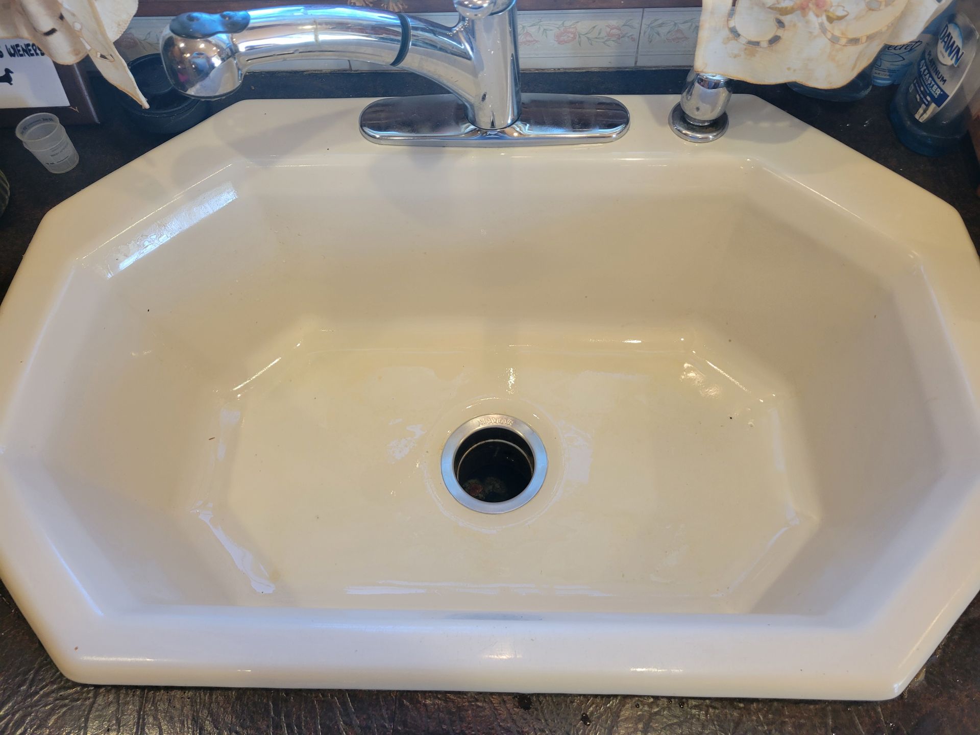 White octagonal sink with chrome faucet.