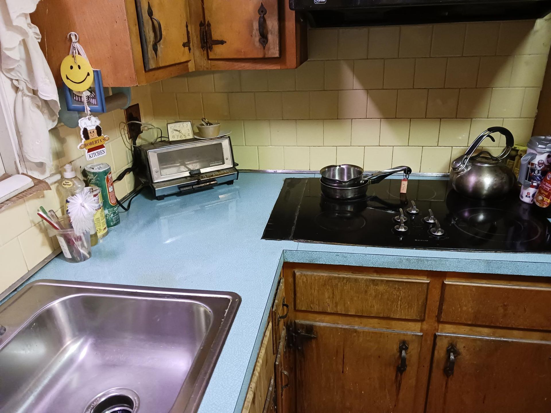 A kitchen with a sink and a stove top oven