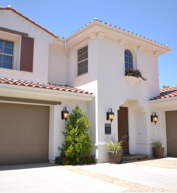 A white house with a brown garage door