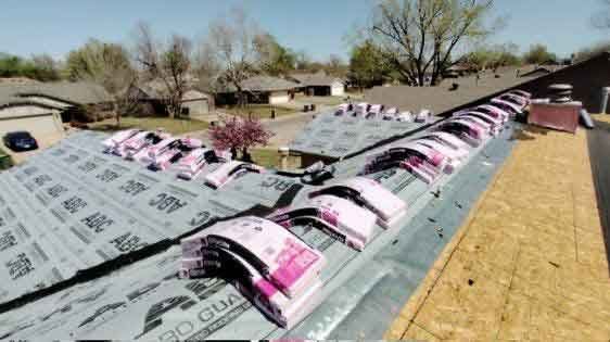 A roof with a lot of shingles on it is being built.