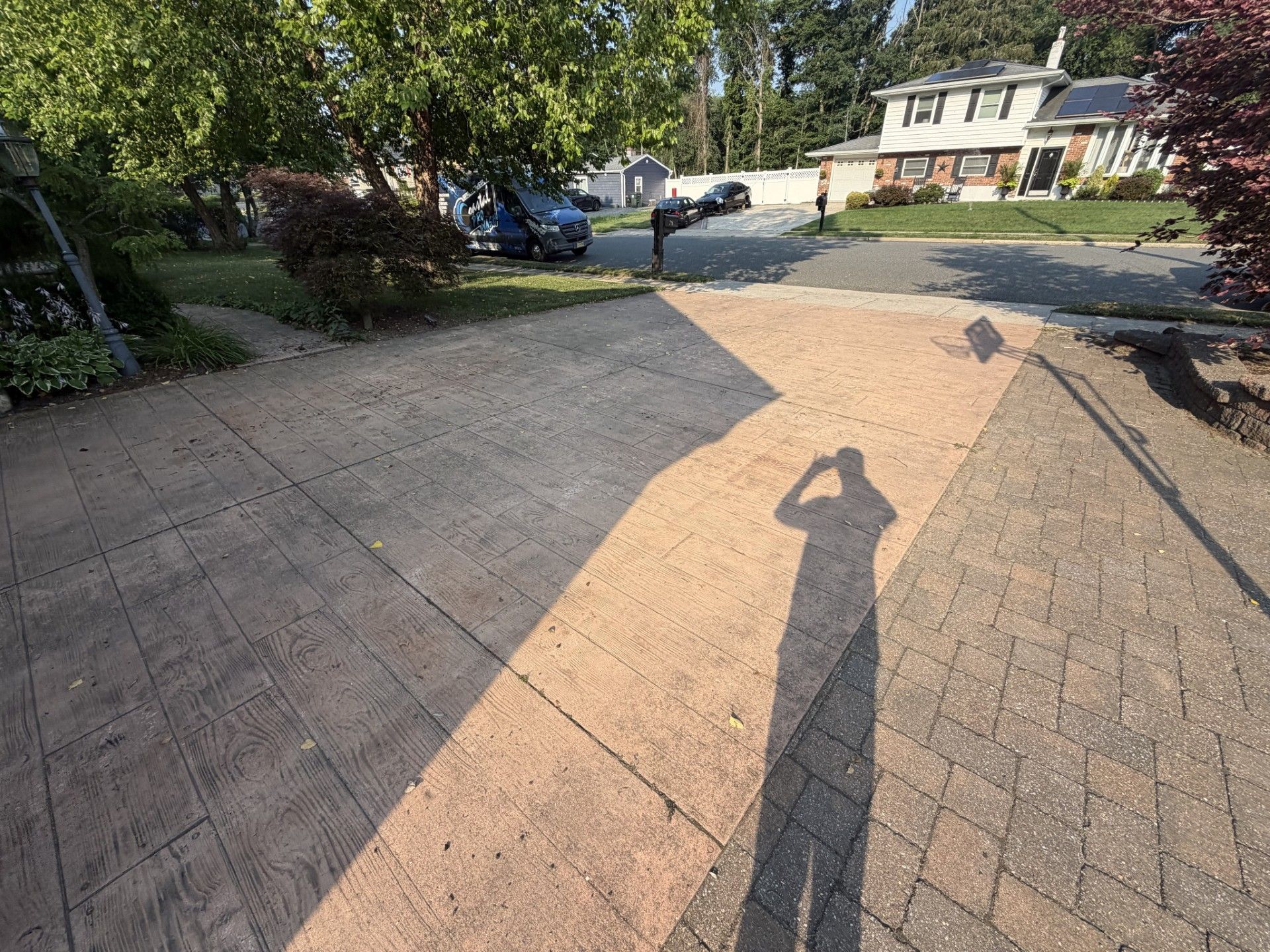 A pressure washer spraying water on a sandy surface, cleaning a wet patch