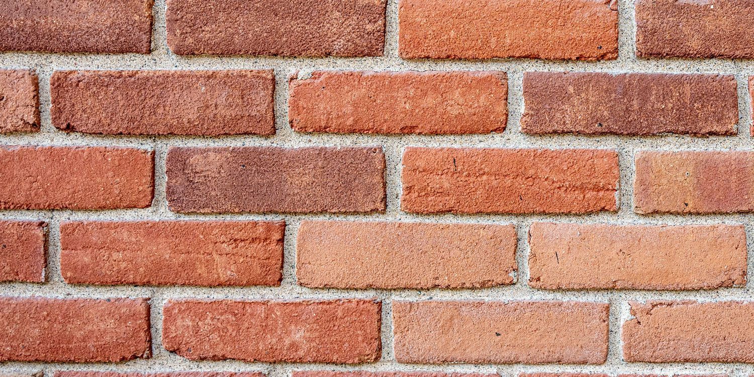 Close-up of a red brick wall with white mortar lines