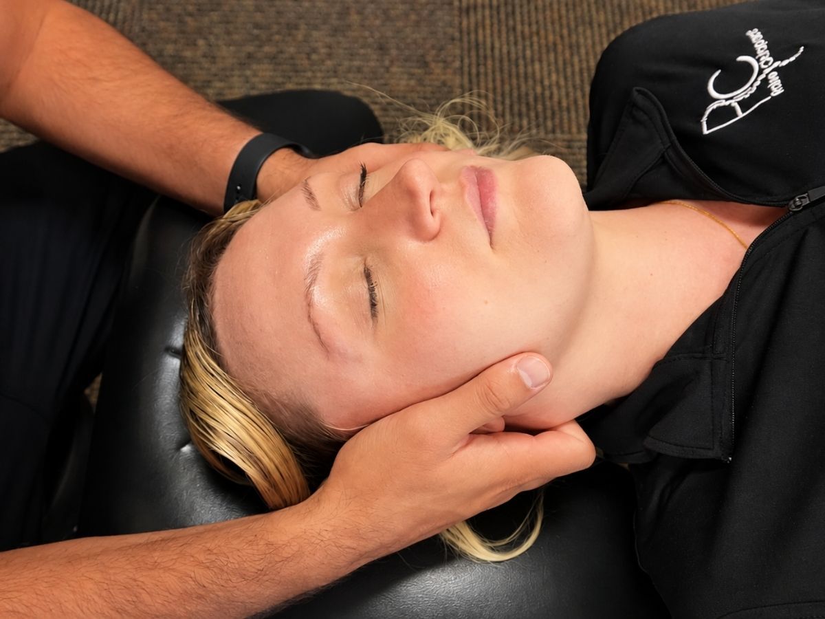 Chiropractic neck adjustment for a patient at Raise Chiropractic in Littleton, Colorado