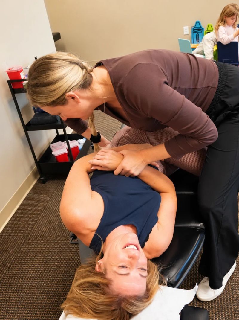 Chiropractor performing a hip adjustment on a patient at Raise Chiropractic in Littleton, Colorado