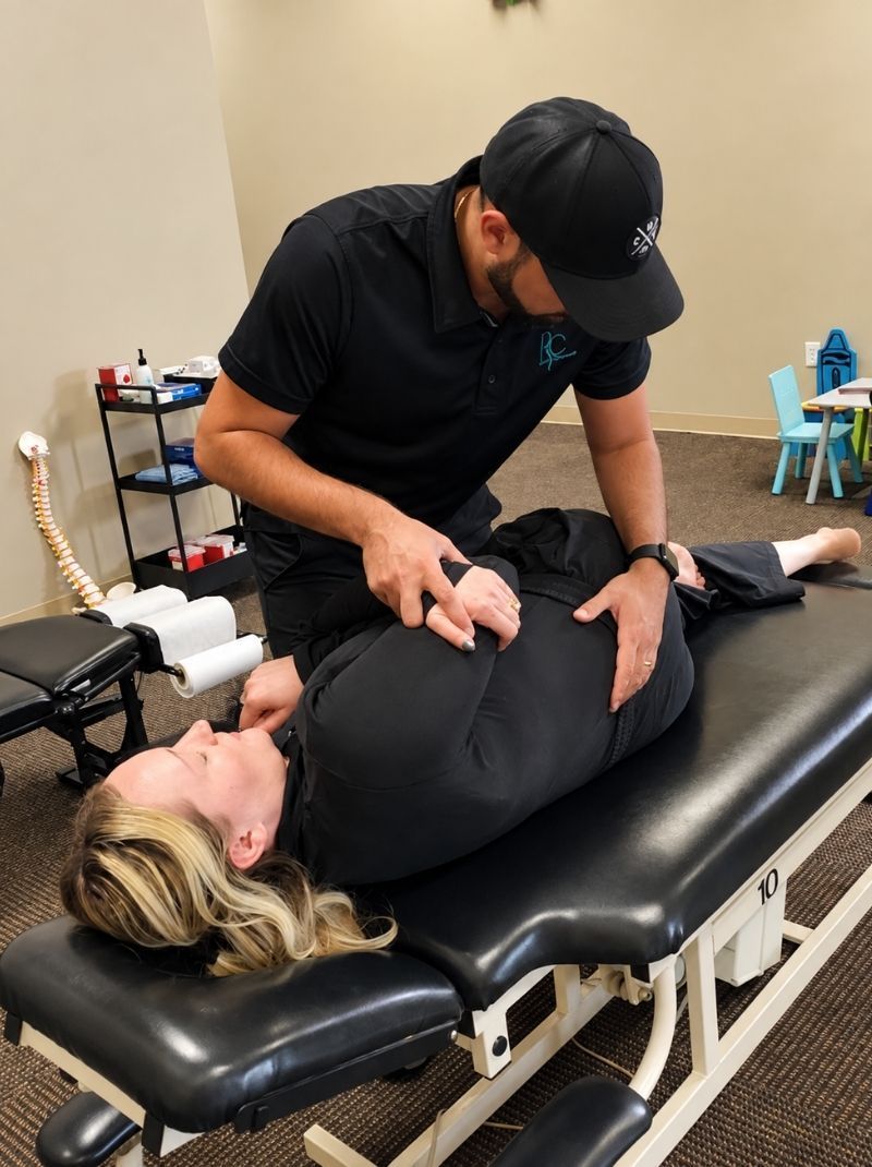 Chiropractor performing a side posture adjustment for lower back pain at Raise Chiropractic in Littleton, ColoradoDr. Neal performing a neck adjustment for a patient at Raise Chiropractic in Littleton, CO