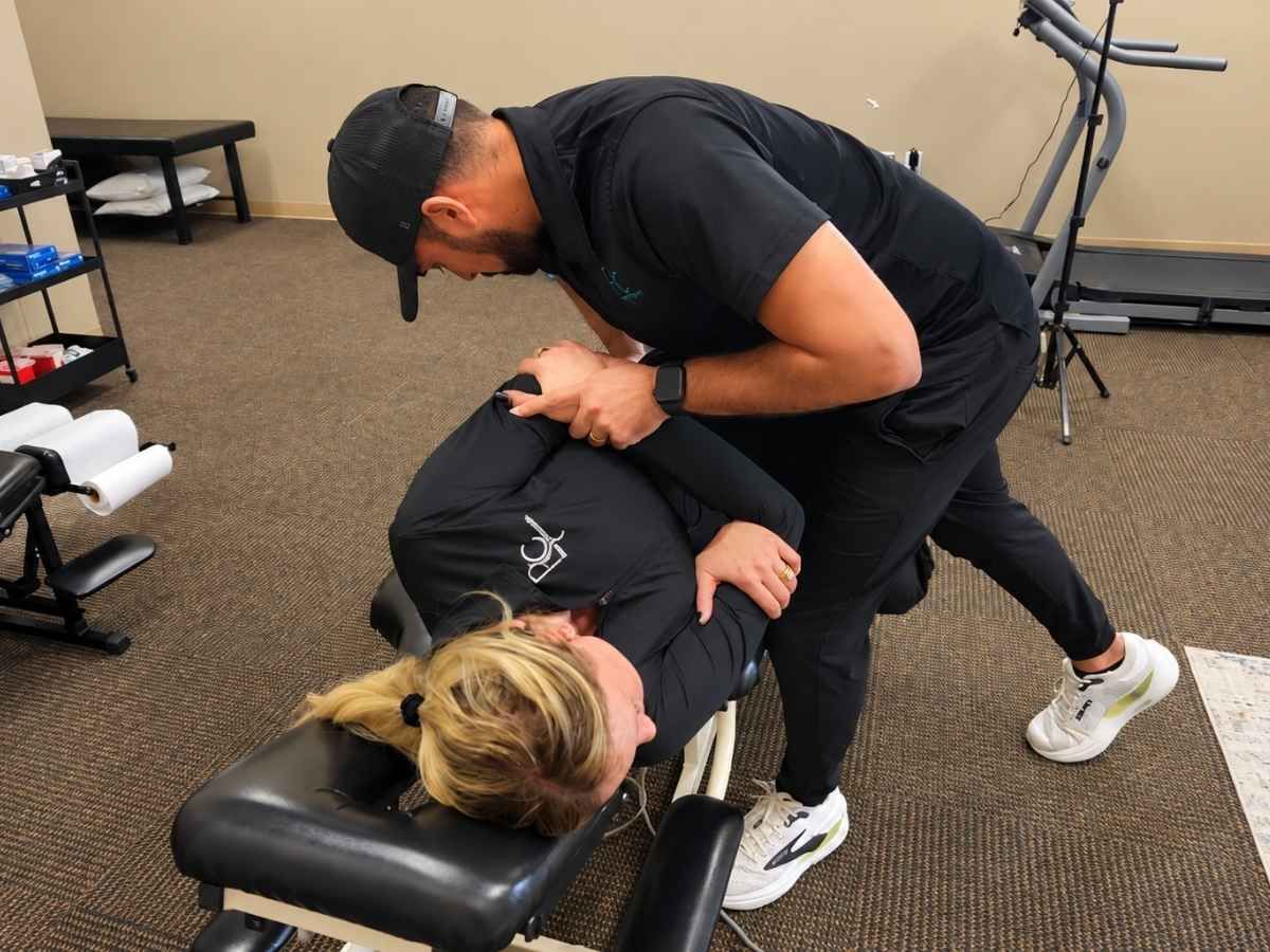 Dr Neal performing a side posture adjustment to a patient for lower back pain at Raise Chiropractic in Littleton, Colorado