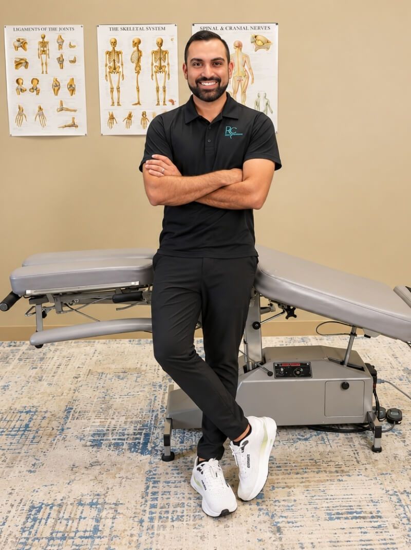 Raise Chiropractic provider standing in a treatment room for carpal tunnel and wrist pain care in Littleton, Colorado