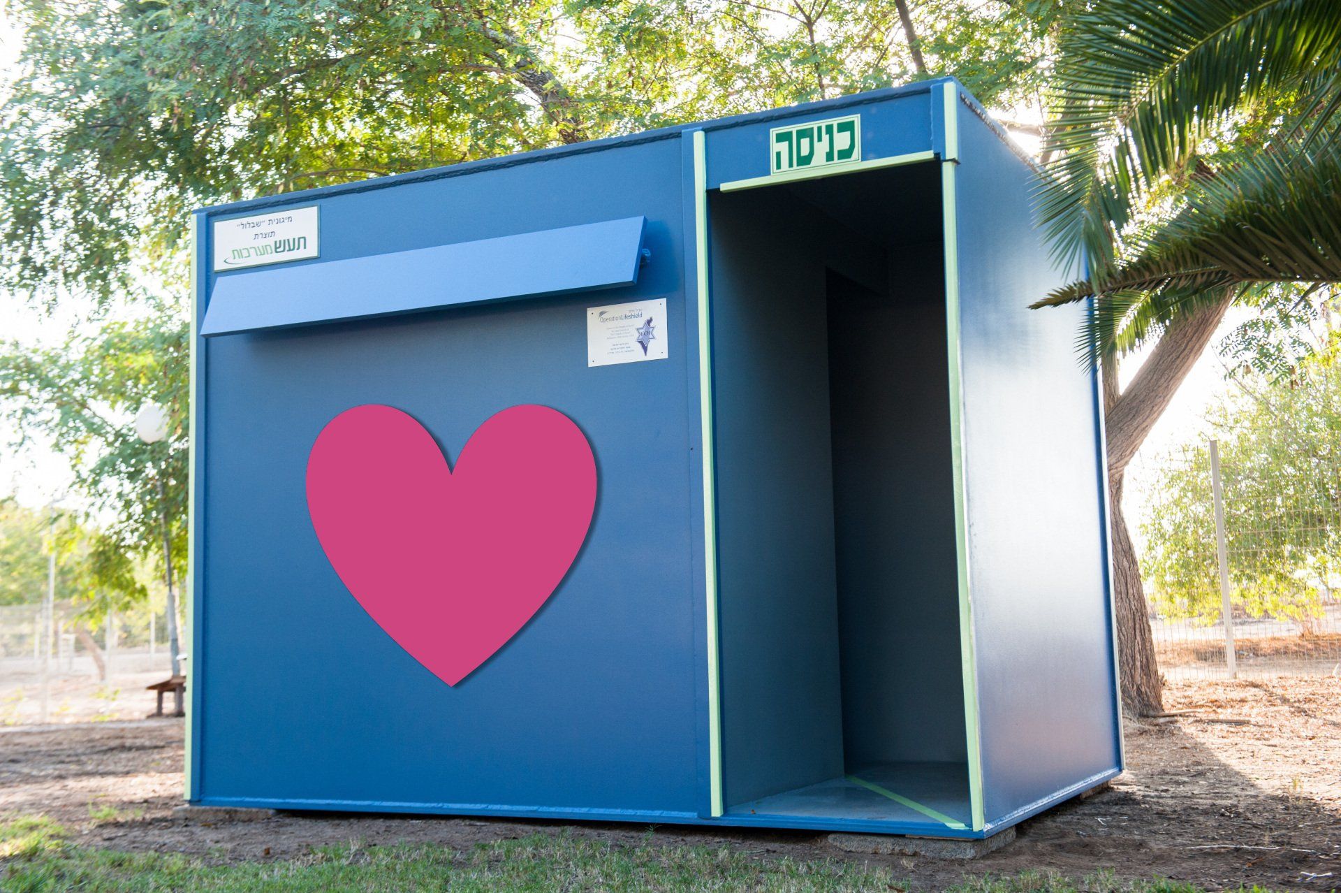A small blue building with a red heart on it