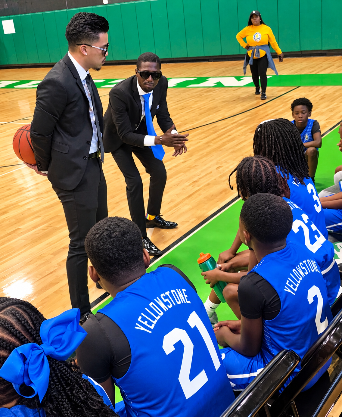 Coaches huddled with a youth basketball team