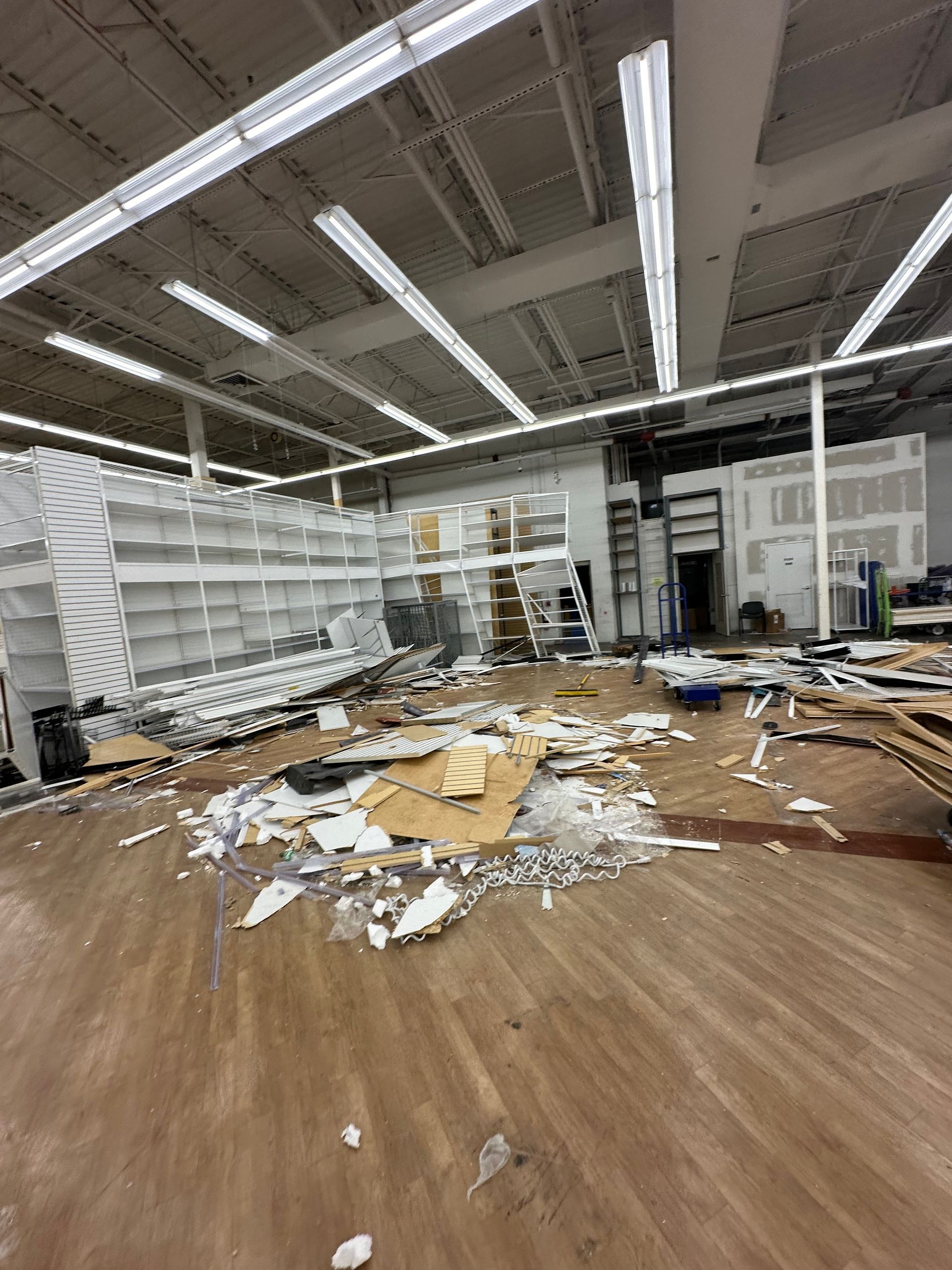 A large room with a lot of trash on the floor.